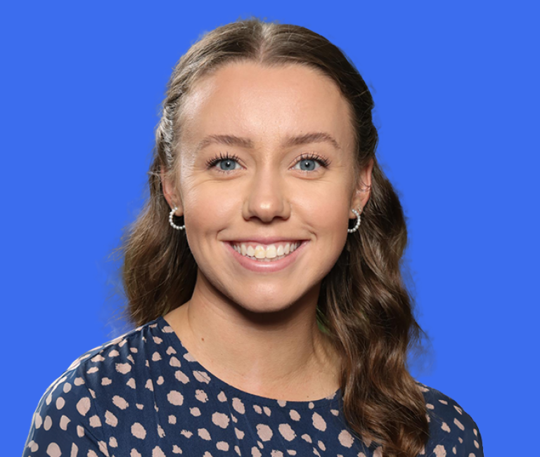 Person smiling on a coloured background