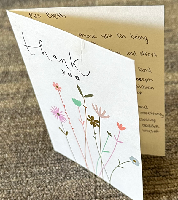 Card with flowers that reads “Thank you”