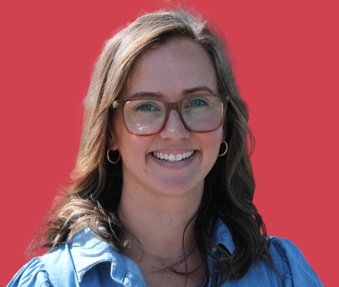 Person smiling on a coloured background