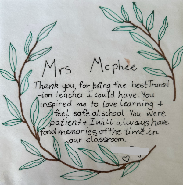 Note that reads ‘Mrs McPhee thank you for being the best transition teacher I could have. You inspired me to love learning and feel safe at school. You were patient and I will always have fond memories of the time in your classroom’. Two drawings of branches with leaves surround the text.